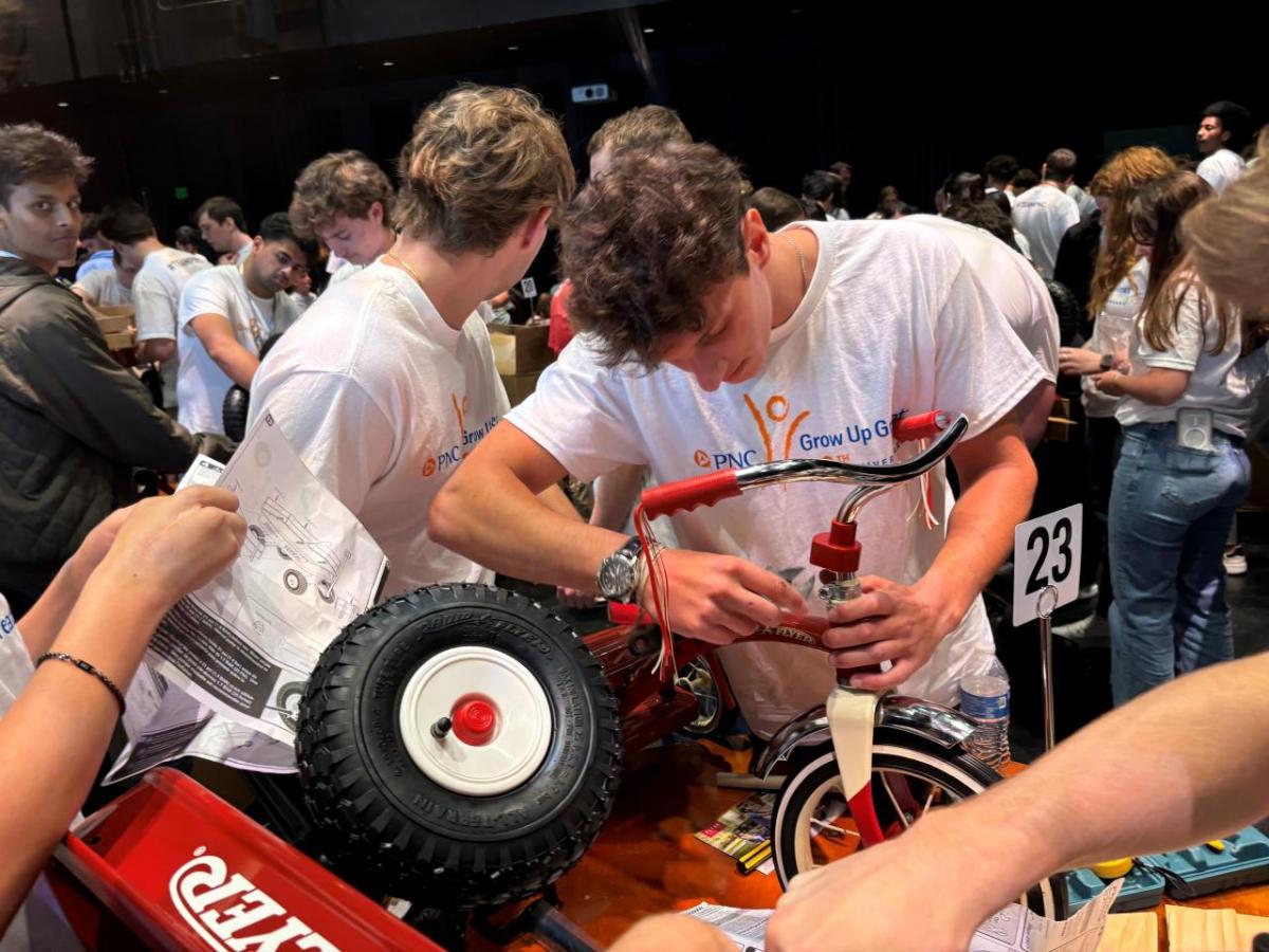 Interns and volunteers working together to assemble bikes and wagons.