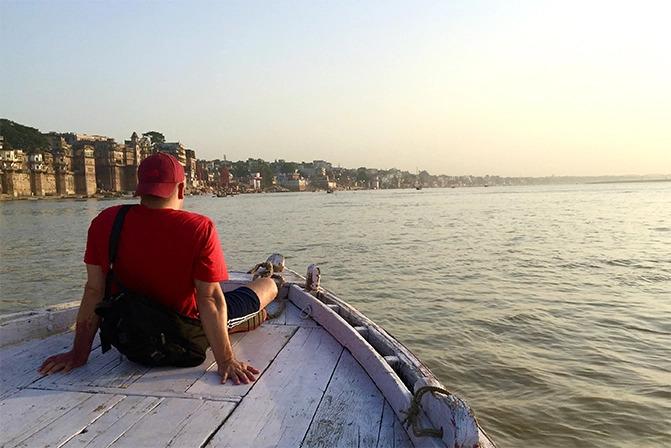 Scott on the bow of a boat on an open expanse of water