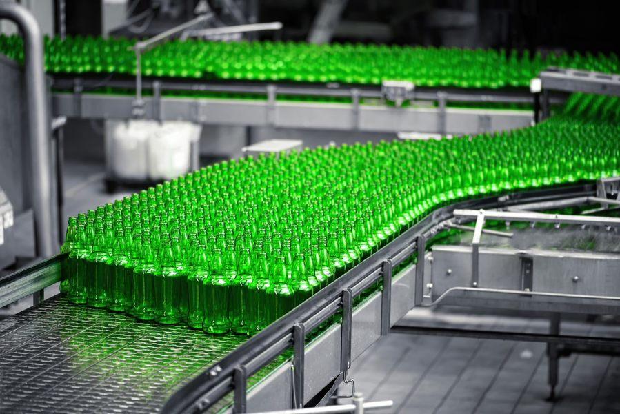 Green bottles on an assembly line