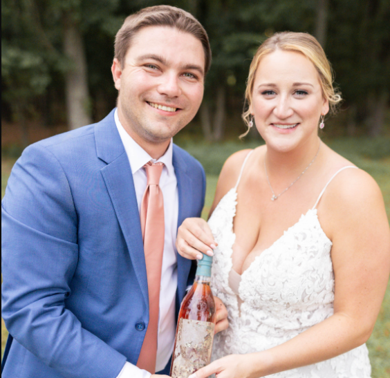 Kyle and his wife dig up a bottle of Yellowstone Kentucky Straight Bourbon Whiskey on their wedding day.  ©Virginia Ashley Photography