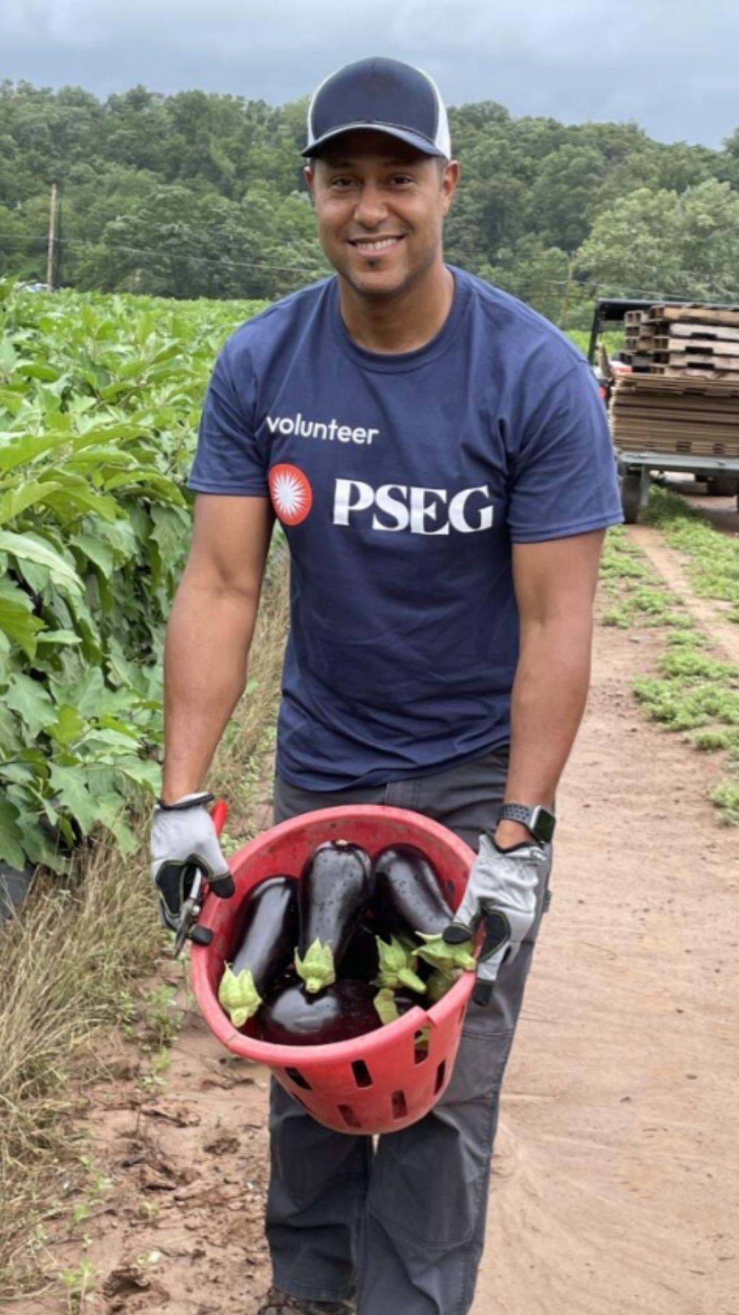 PSEG volunteer with a basket of eggplant