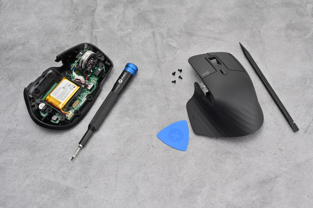 A broken computer mouse and tools