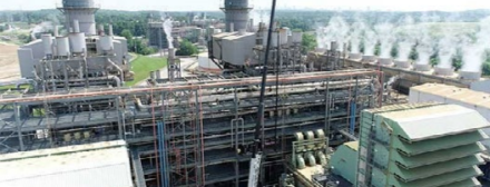 Aerial view of huge power plant, steam stacks to the right.