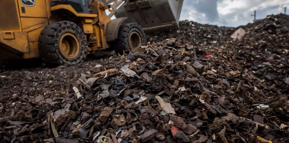 Bulldozer scoops up automotive waste