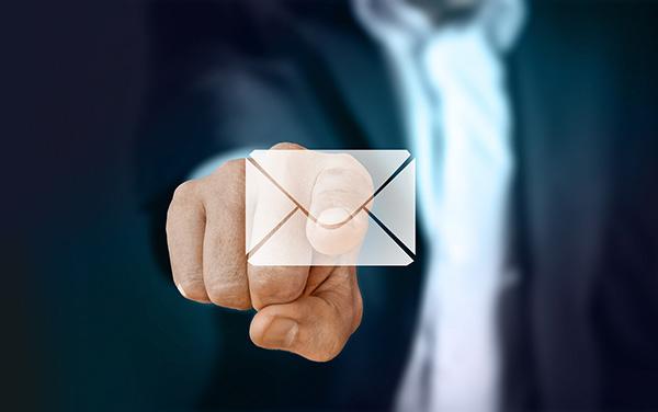 A person pointing at an email illustration 