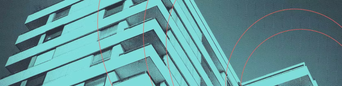 The side of a tall building, a green tint over the whole image.