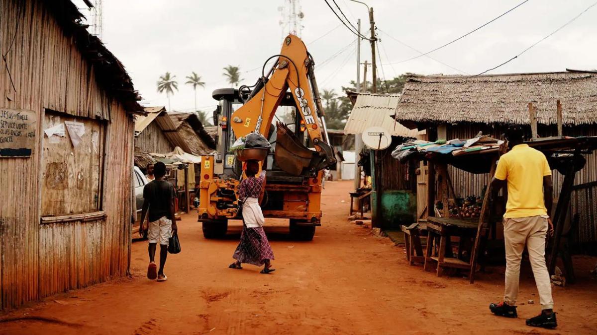 A piece of machinery driving through a street 