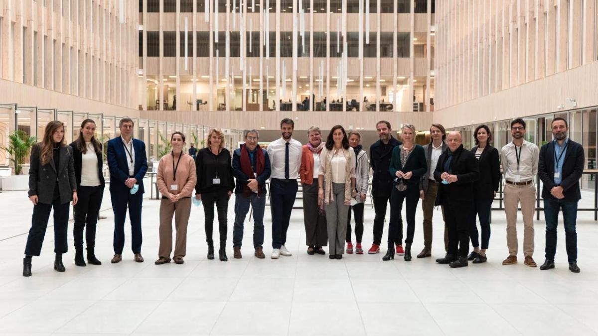 A line of people posed in an open area.