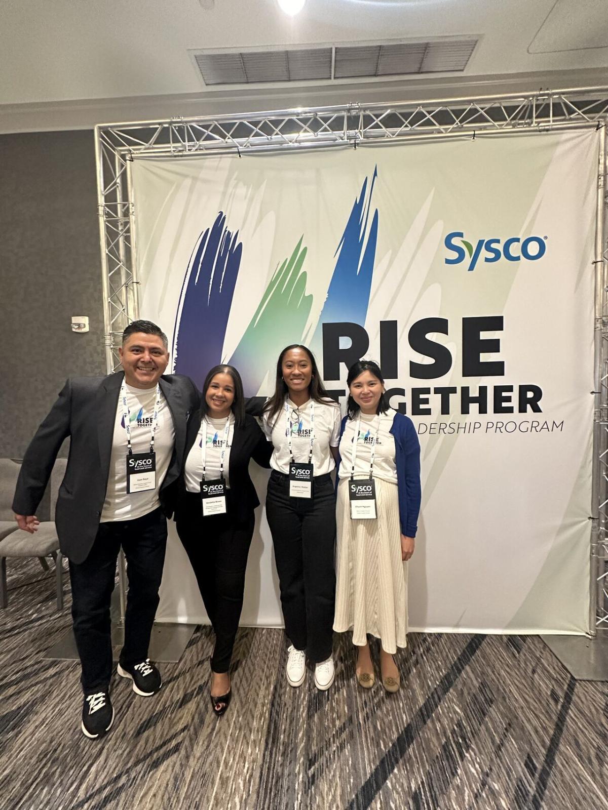 Four people standing together