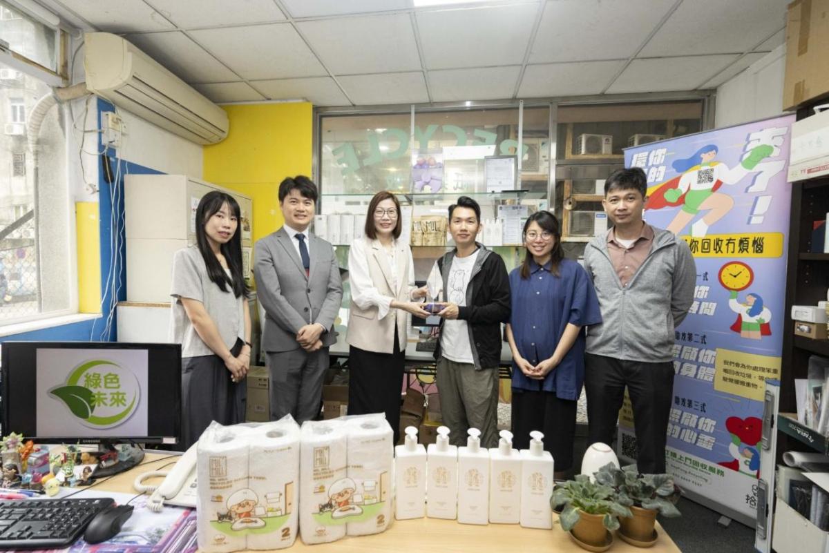 6 people standing behind products, holding an award