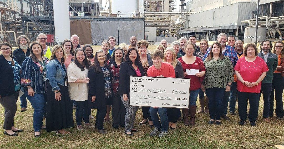 Group of people with a big check from International Paper 