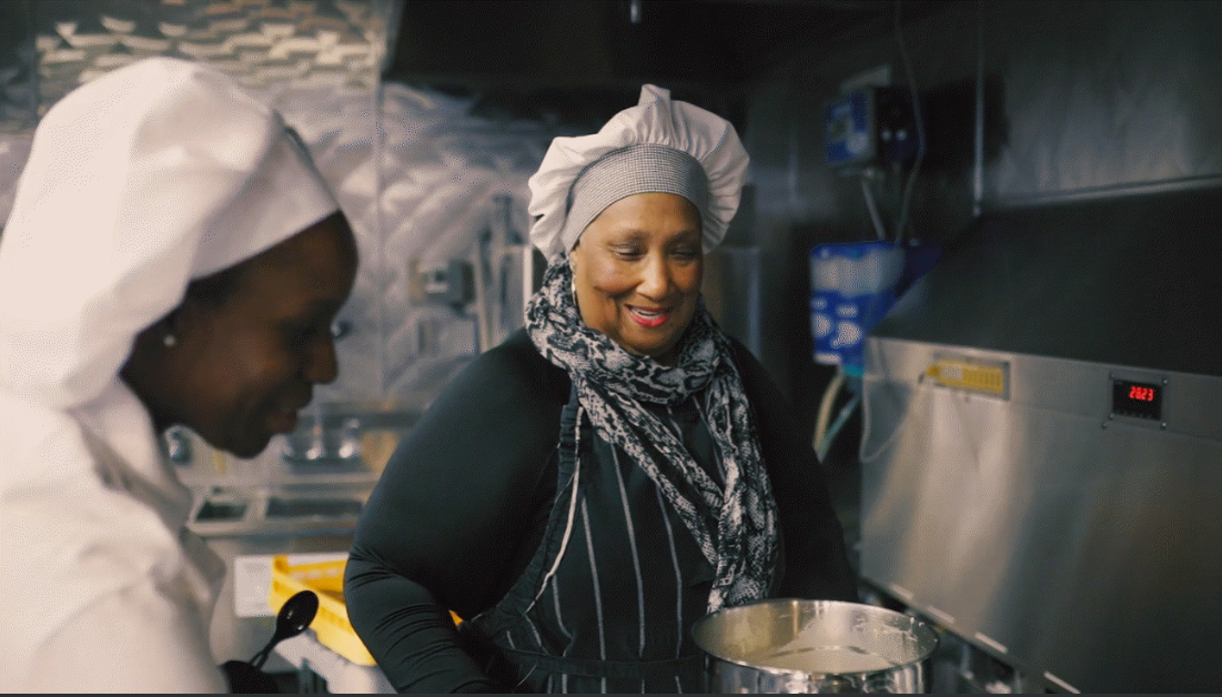 Chef Cherie Beasley with chef hat in kitchen