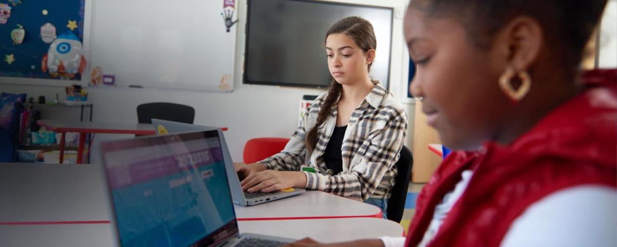 children working on laptops