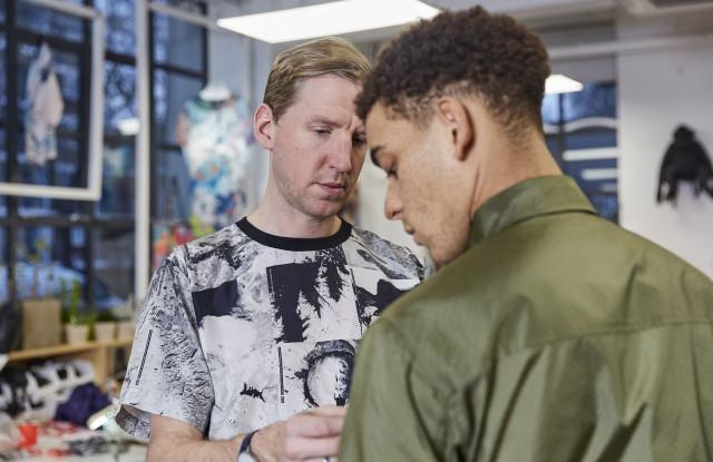 Christopher Raeburn fitting a model in one of his looks. Photo by Olivia Thompson, courtesy WWD