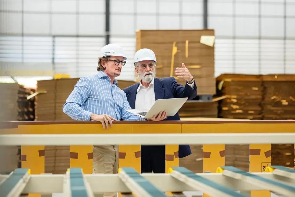 GETTY Two people in hard hats in a manufacturing scene.