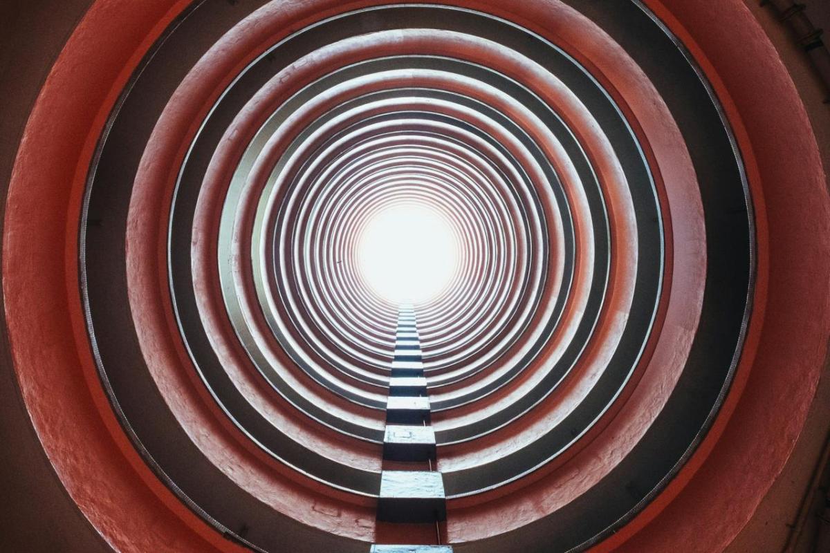 Looking through a long tunnel towards a bright light.