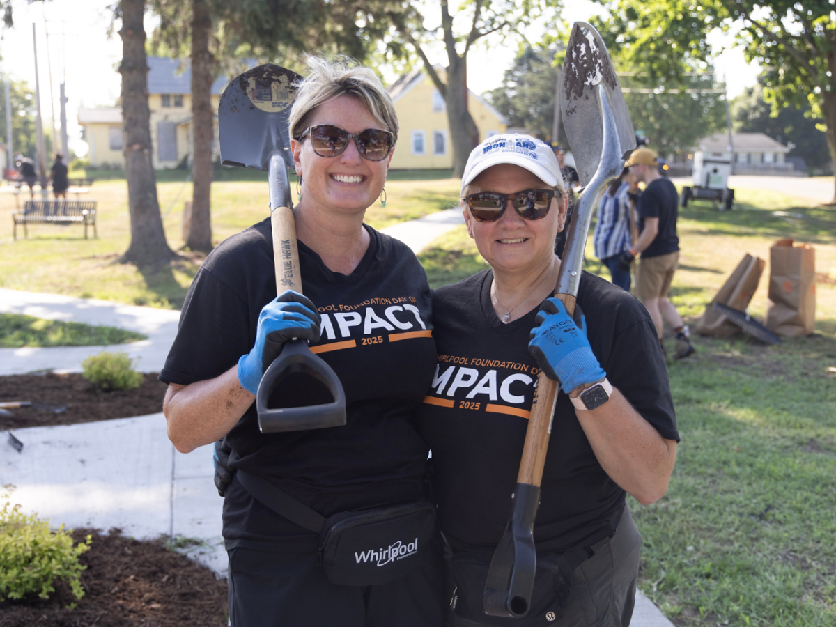 two volunteers with garden tools