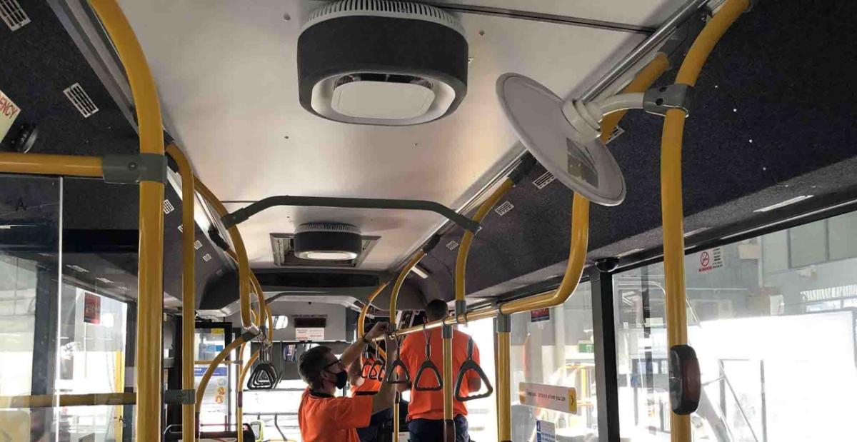 people cleaning a bus empty of passengers