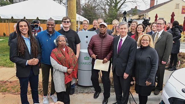 A large group of people outside in a residential area.