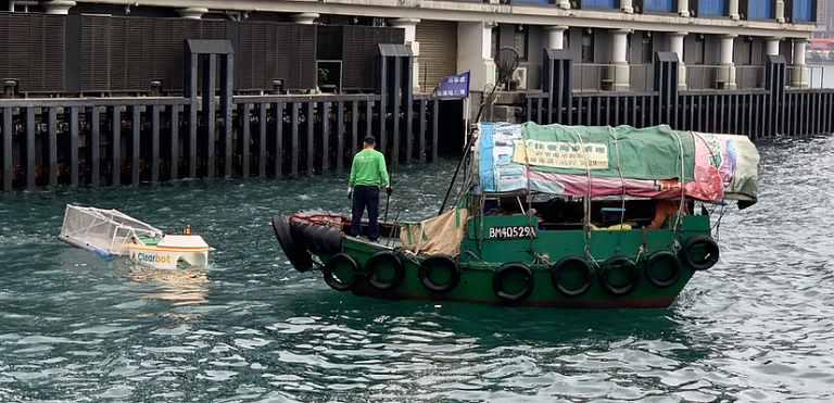 Clearbot’s robotic solution (left) versus traditional collection method using nets. Clearbot (left) and small boat on a river