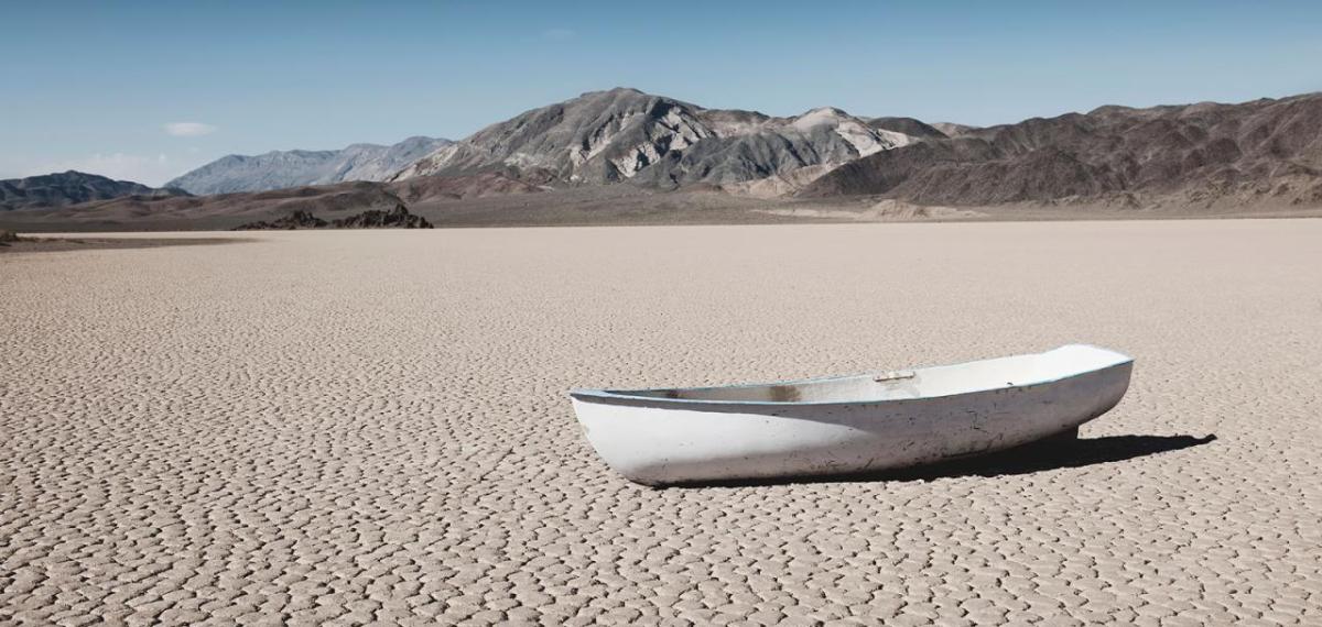 A small boat in a barren desert landscape.