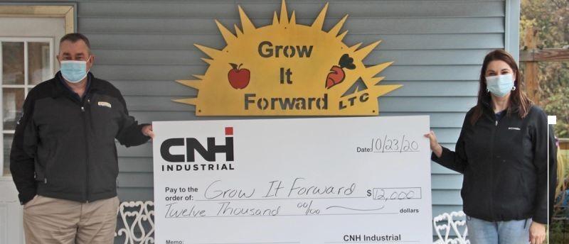 Devin Tompkin, CNH Industrial St. Nazianz Plant Manager and Heather Martin, St. Nazianz Human Resources Representative, handed over the check to Grow It Forward.