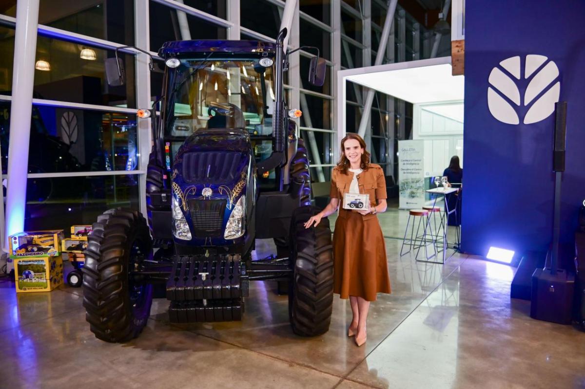 person standing with commemorative tractor