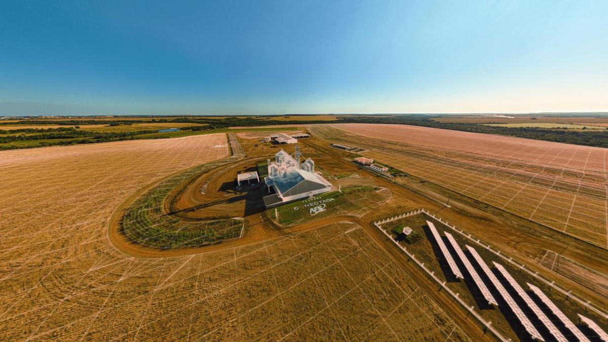 Aerial view of a farm in a very large crop field.