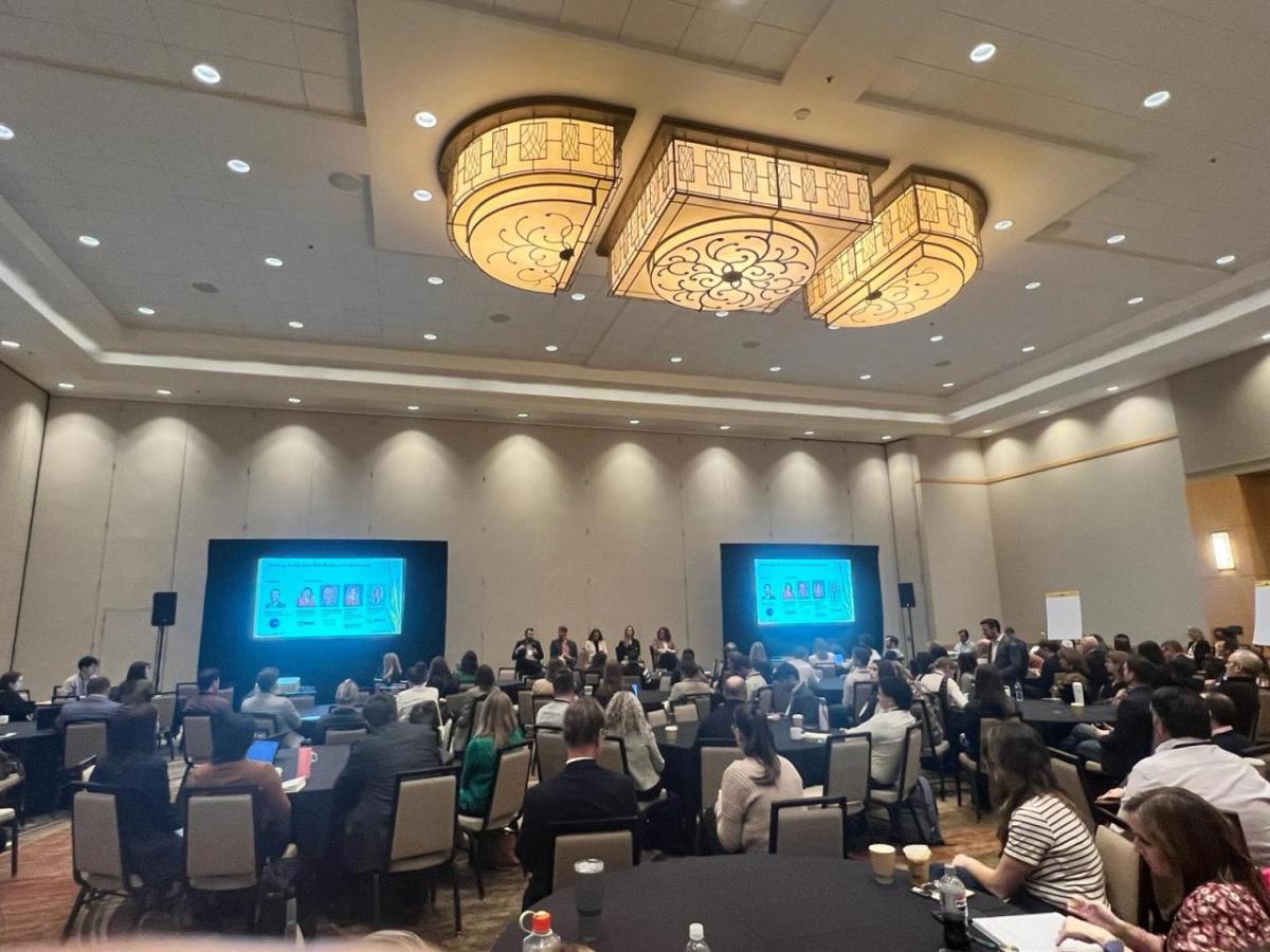 Conference room filled with people at tables and chairs