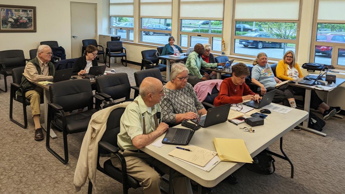 Group of people learning computer skills