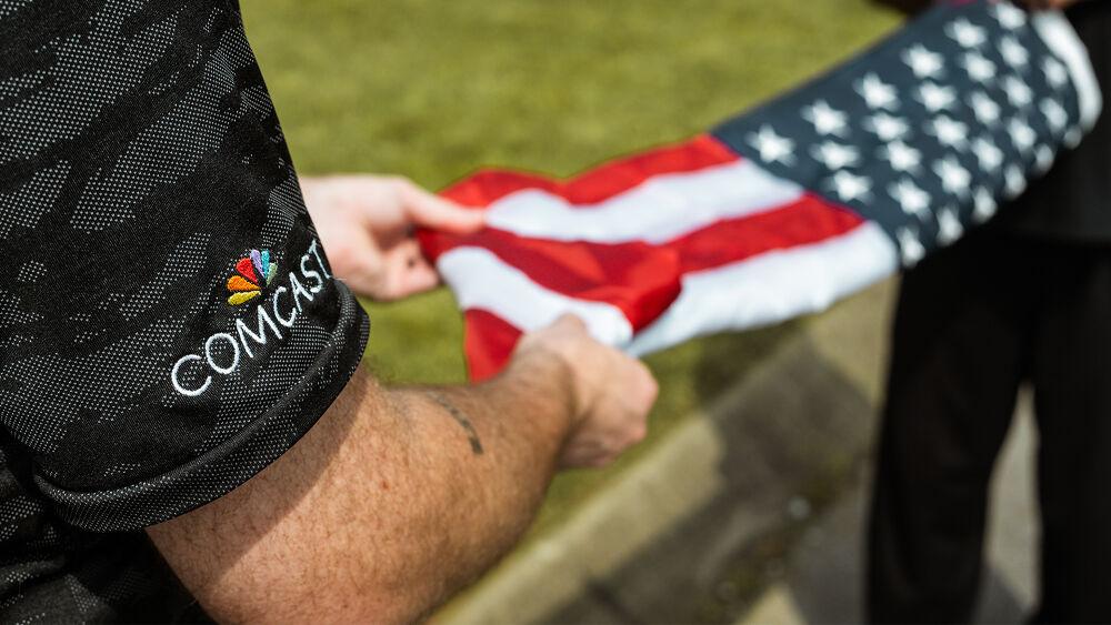 Cloes up of two people folding an american flag.