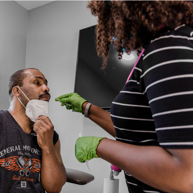 a healthcare provider does a nose swab of another person