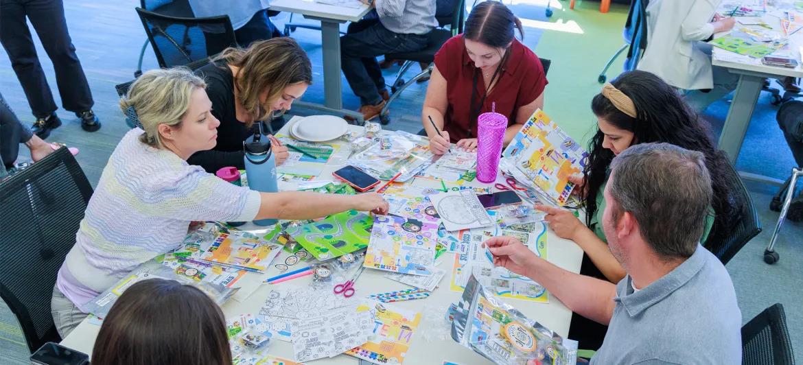 A group of volunteers at a table with craft supplies