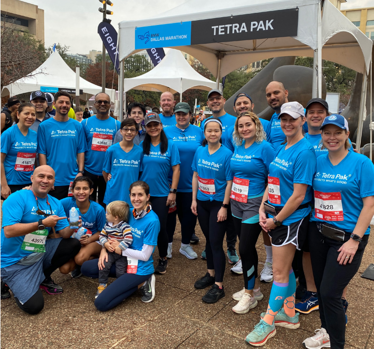 A posed group of runners and fans.