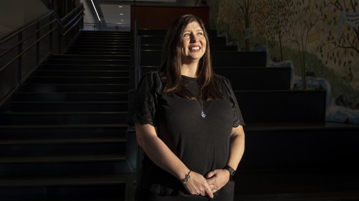 Dawn Martesi stood in front of a stair case