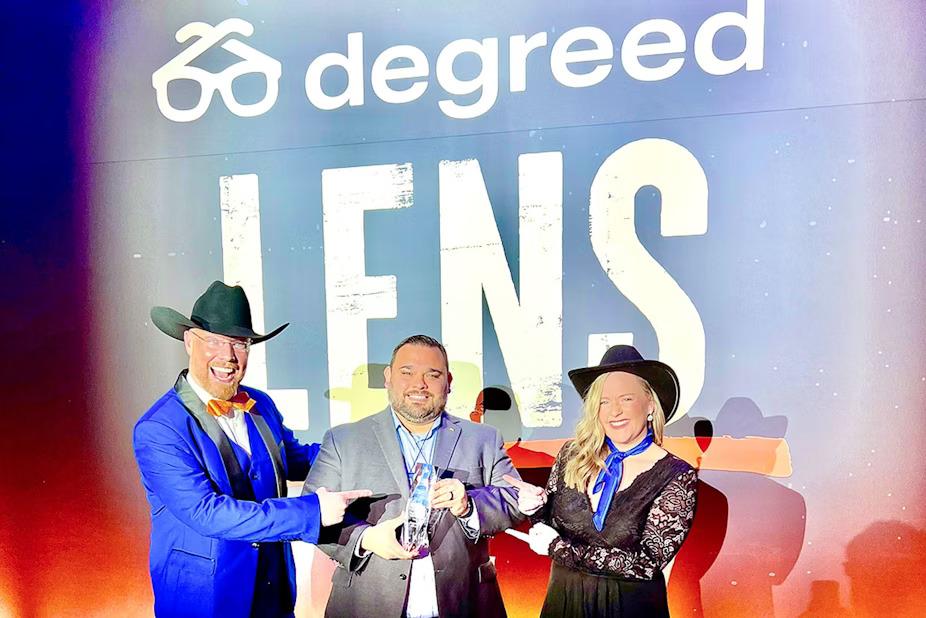 Regions Learning Coach Oscar Silva (middle) is presented the bank's award by two Degreed employees. " "