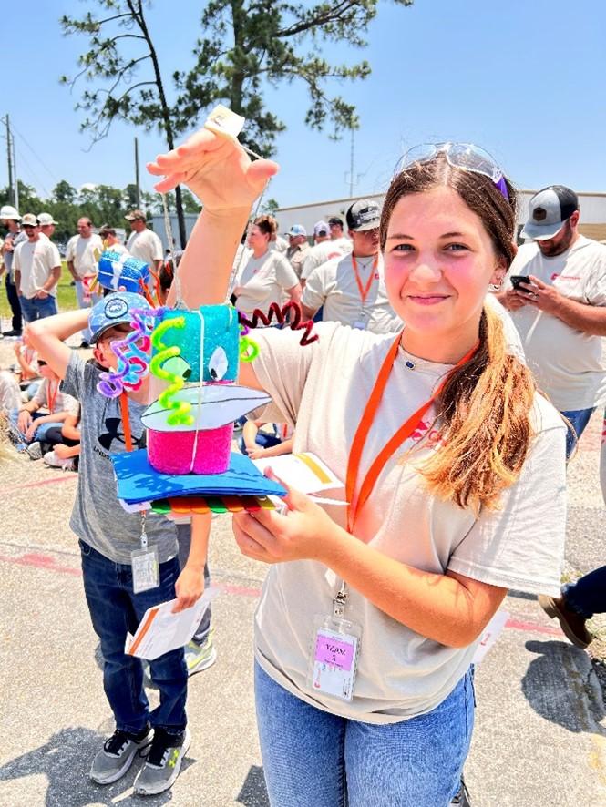A person holding up a colorful handmade item