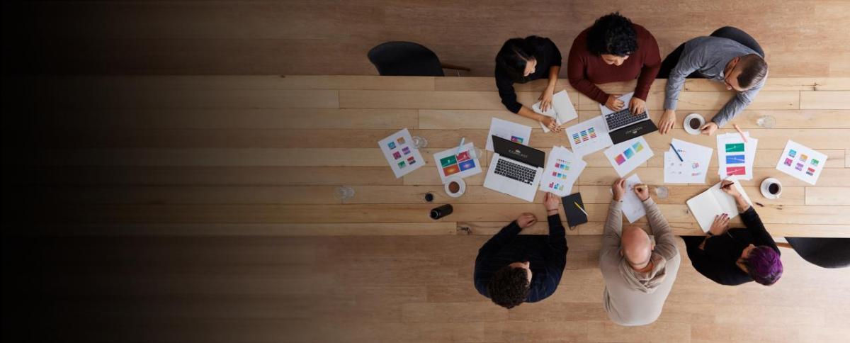 bird's eye view of people working at a desk