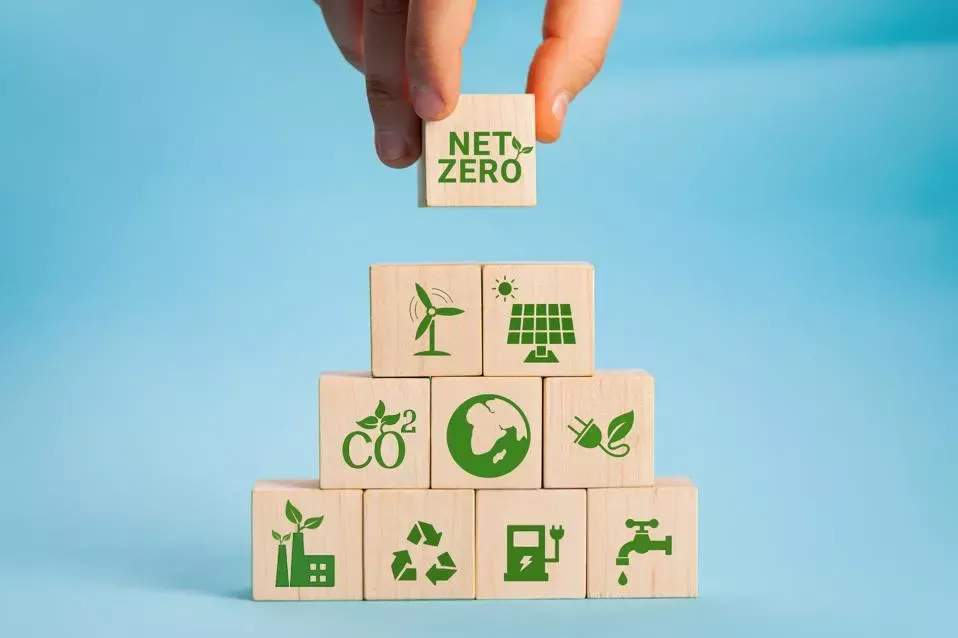 person adding "net-zero" block on top of other blocks