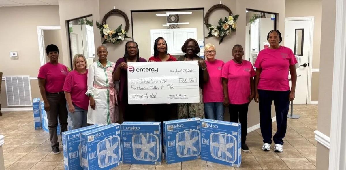 people with window fans and a donation