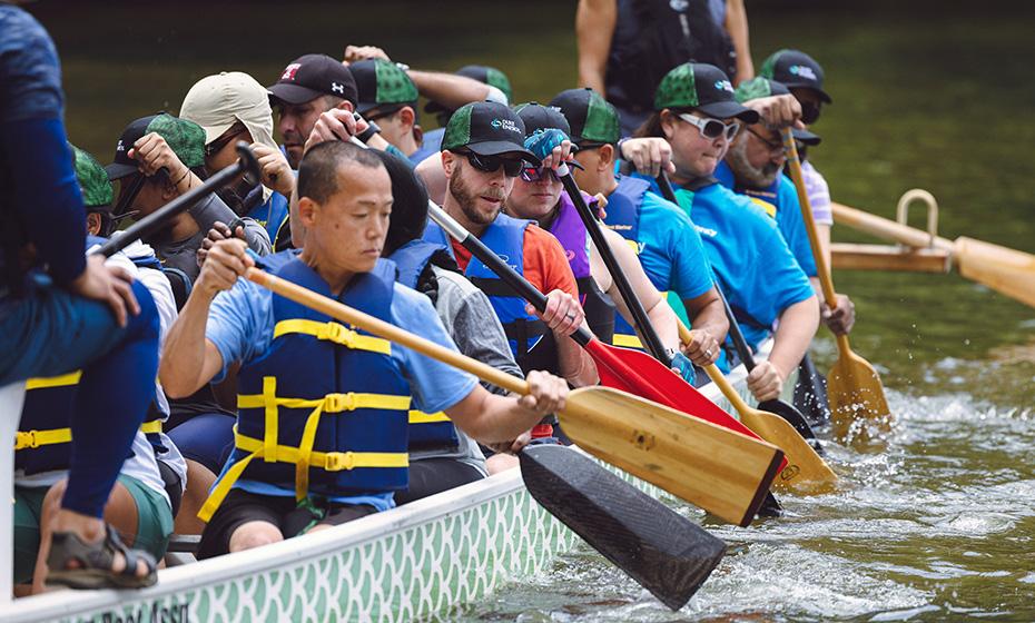 Duke Energy's Electric Glide team paddle in the water