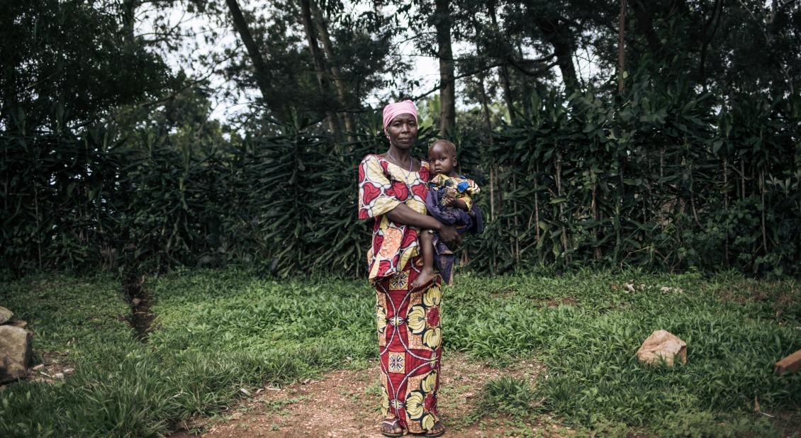 Georgine Dz'dha Nzale holds her 27-month-old son, David Wauba, who suffers from severe acute malnutrition, near the Drodro Health Center in Ituri, northeastern Democratic Republic of Congo. Here, Action Against Hunger manages treatment for severely malnourished children. 
