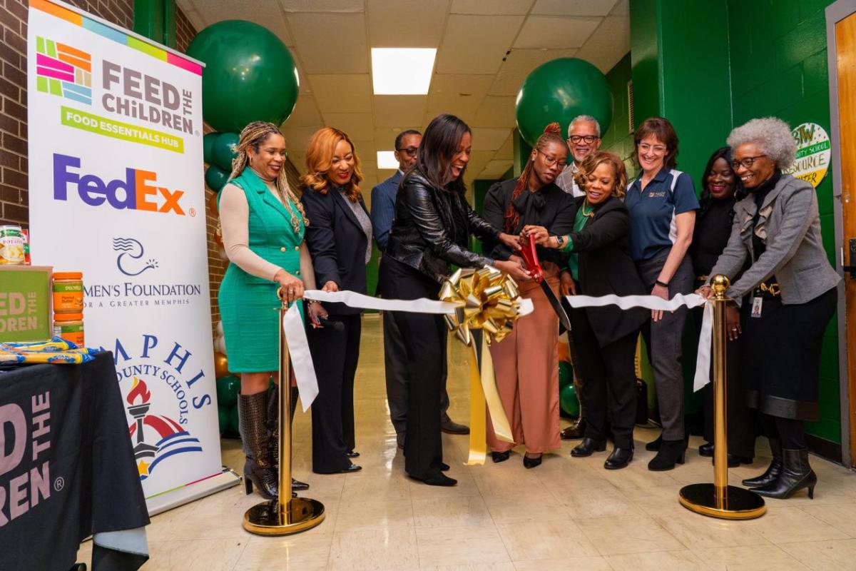 People performing a ribbon cutting ceremony
