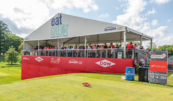 People stood watching a golf tournament