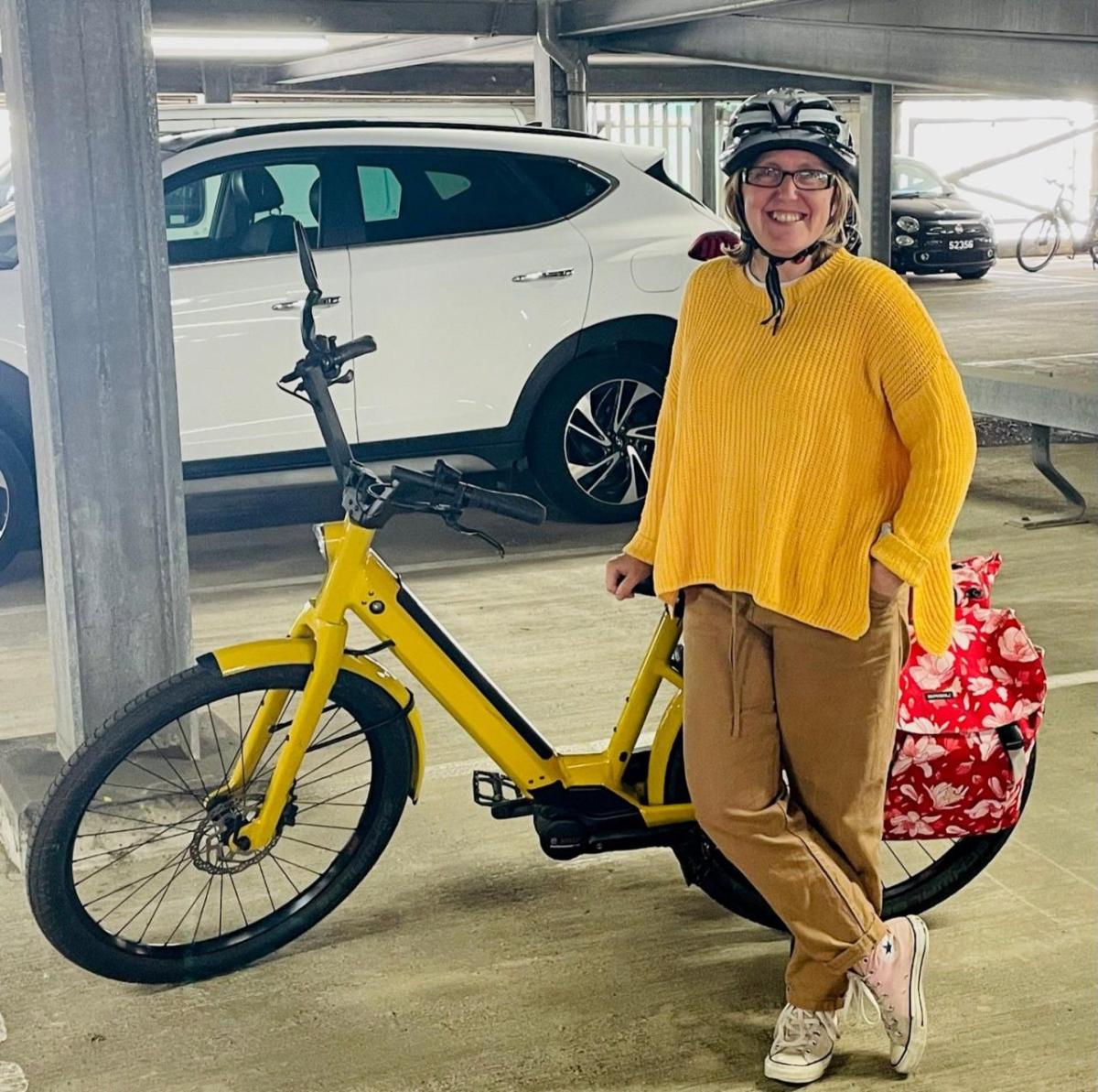 A person next to a parked e-bike.