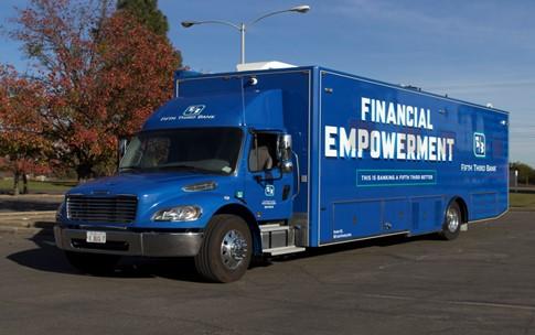 Blue semi trailer with "Financial Empowerment" on the side.