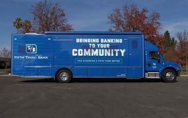 A semi trailer in all blue with "Bringing banking to your community" on the side with 5/3 logo.