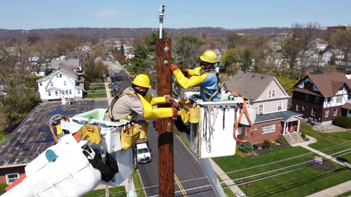 Workers up on electrical pole