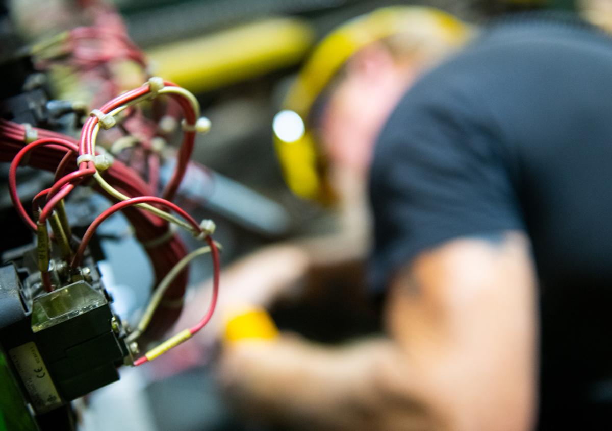 An electrician working, wires in the foreground