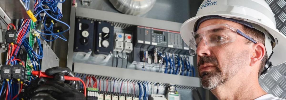 An electrician working with wires and tools.